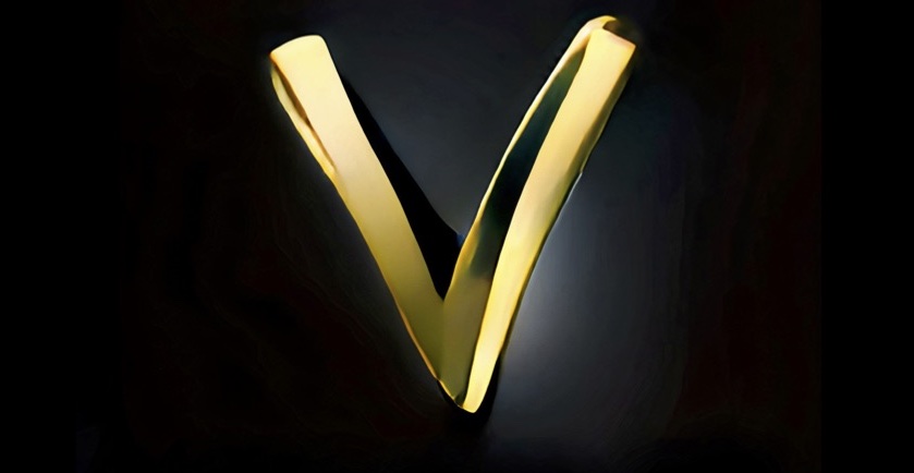A bling golden letter V against a dark background